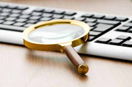 magnifying glass and keyboard